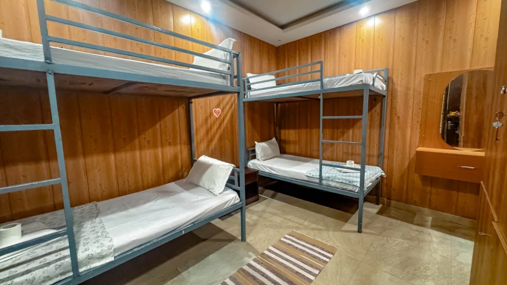 Six-sharing dormitory layout at the Rishikesh yoga school