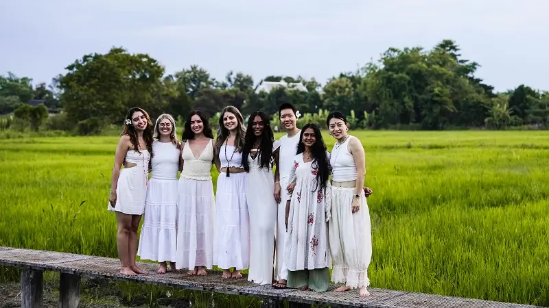 Graduating group on the walkway through the rice fields