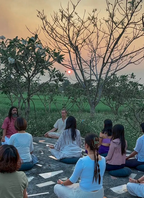 The group sitting together outdoors at sunset