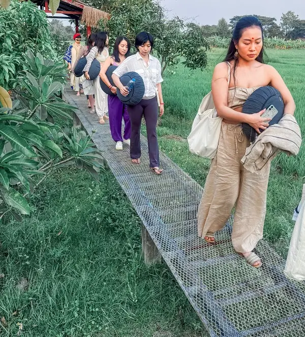 Guests carrying their cushions out to the morning sitting spot