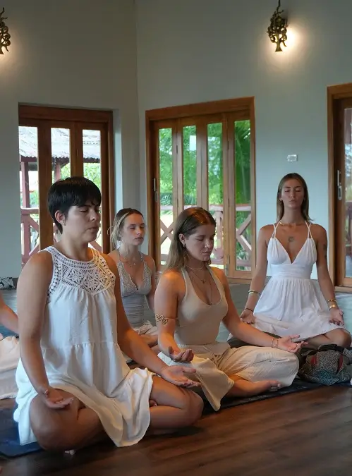 Students sitting in silent meditation at dawn