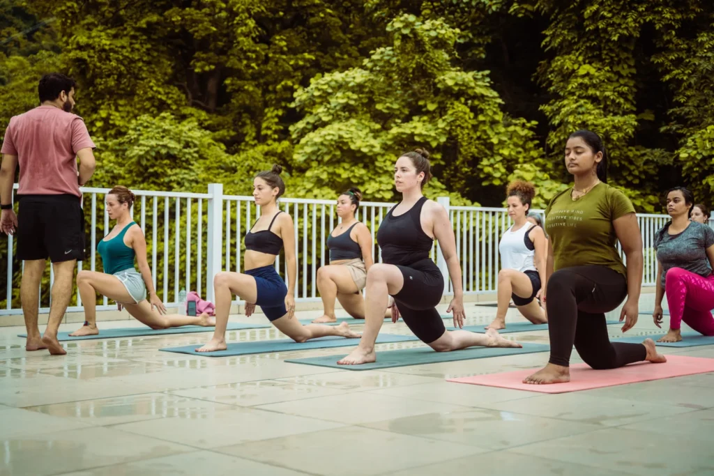 A group of students performing Vinyasa yoga sequences during a structured teacher training program at Vinyasa Yoga Academy