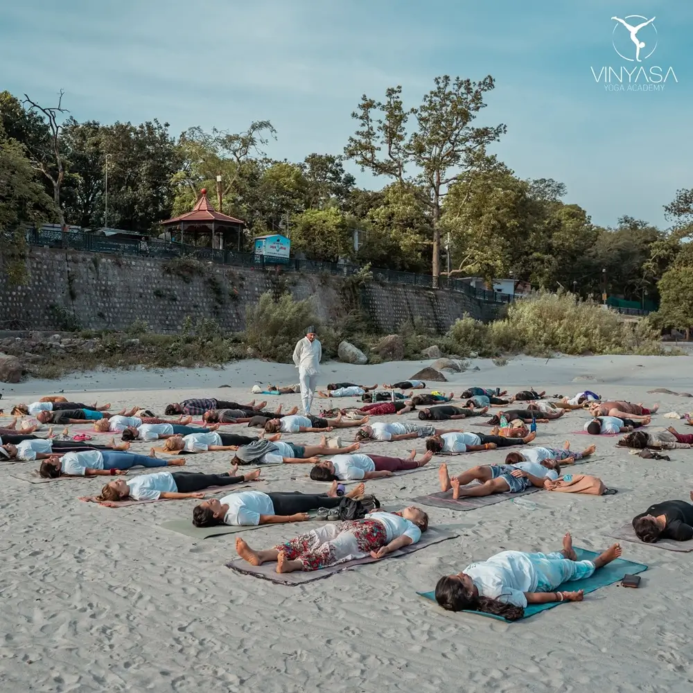 Group practicing Yoga Nidra outdoors on yoga mats