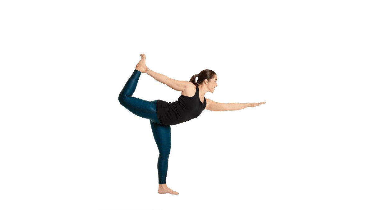 Portrait of attractive happy young woman working out indoors, doing yoga  exercise, variation of Natarajasana, Lord of the Dance, King Dancer or  Standing Mermaid Pose. Stock Photo | Adobe Stock