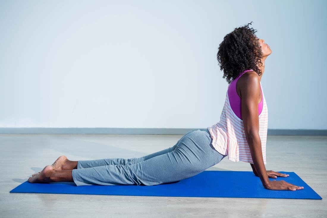 Woman doing Ashtanga Vinyasa Yoga asana Prasarita padottanasana Stock Photo  by ©DmitryRukhlenko 117557600