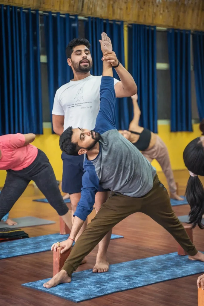 Yoga teacher giving alignment