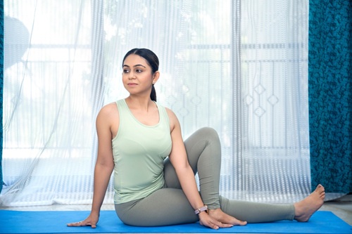 A Woman Practicing Vakrasana A Woman Practicing Vakrasana